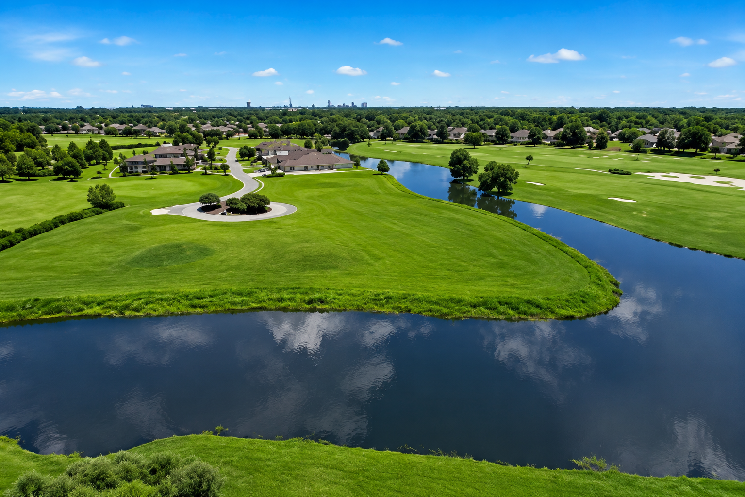 Aerial view of professionally presented green space and waterfront grounds